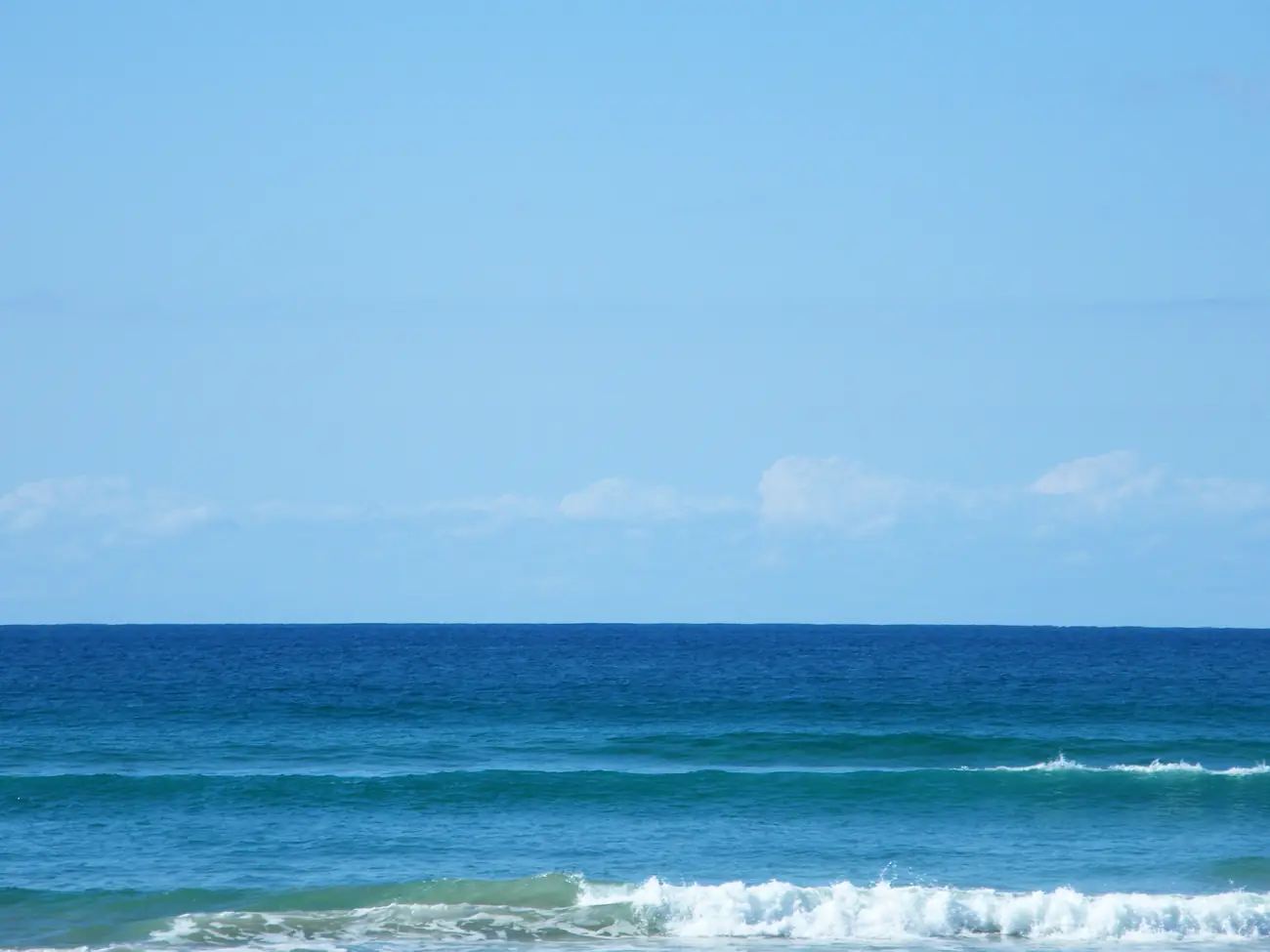 The coastline at Burleigh Heads on the Gold Coast, with cloud on the horizon over the surf