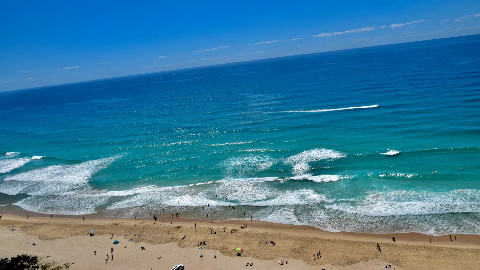 The Surfers Paradise beachfront on Australia's Gold Coast, high-rise towers behind a wide sand beach