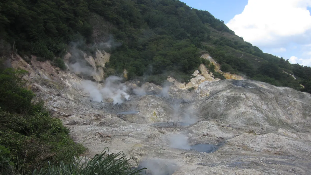 Steaming vents and grey mineral pools at Sulphur Springs, Soufrière, Saint Lucia