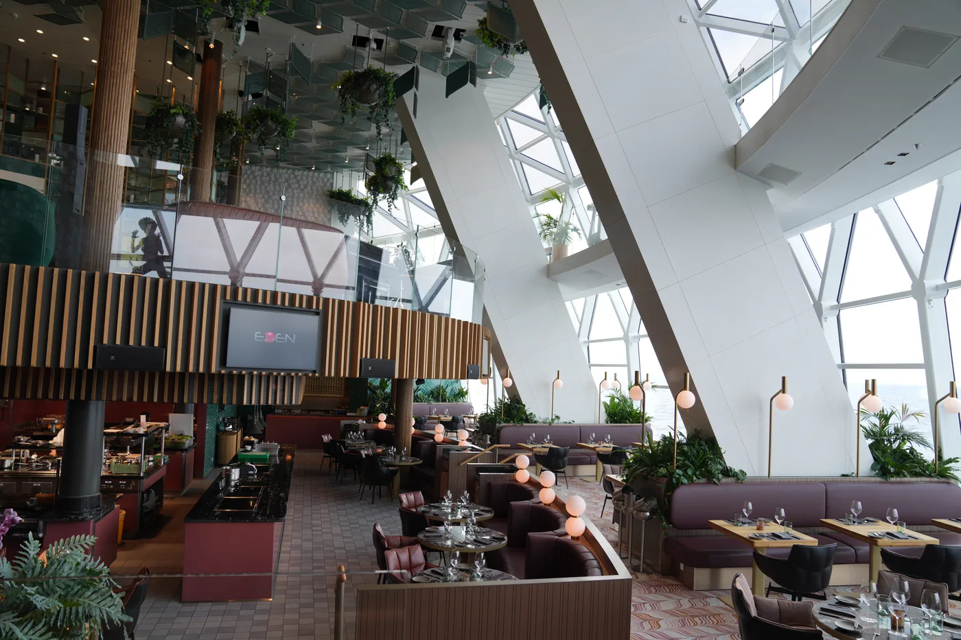 Eden aboard Celebrity Apex — the multi-deck glass venue that Xcel replaces with The Bazaar