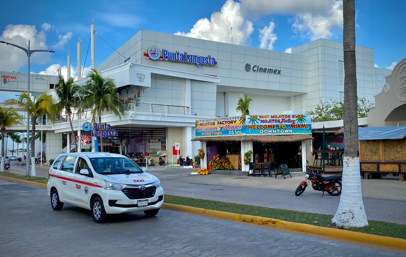 The Punta Langosta pier at San Miguel de Cozumel, its walkway crossing the waterfront road into the town