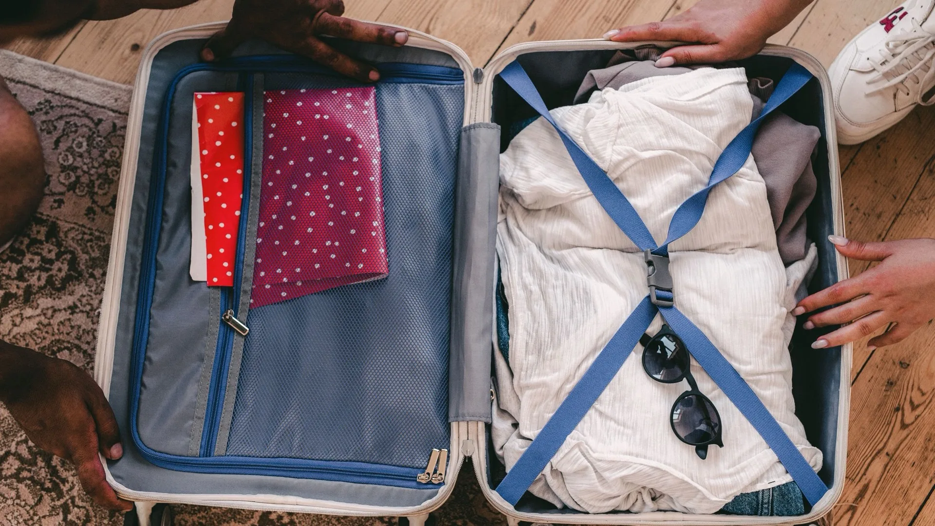 An open suitcase neatly packed with folded clothing and travel essentials