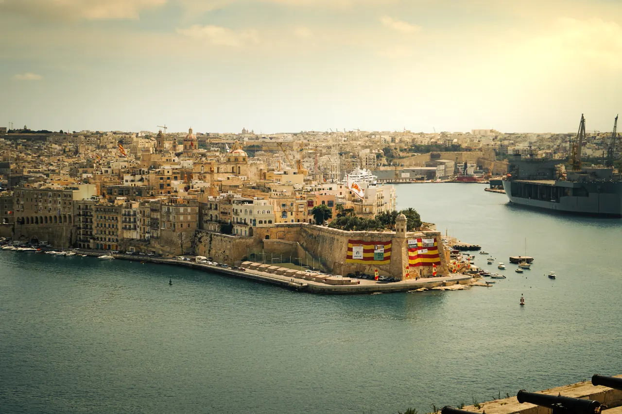 Experience the breathtaking beauty of Valletta’s historic coastline in Malta during a serene sunset.