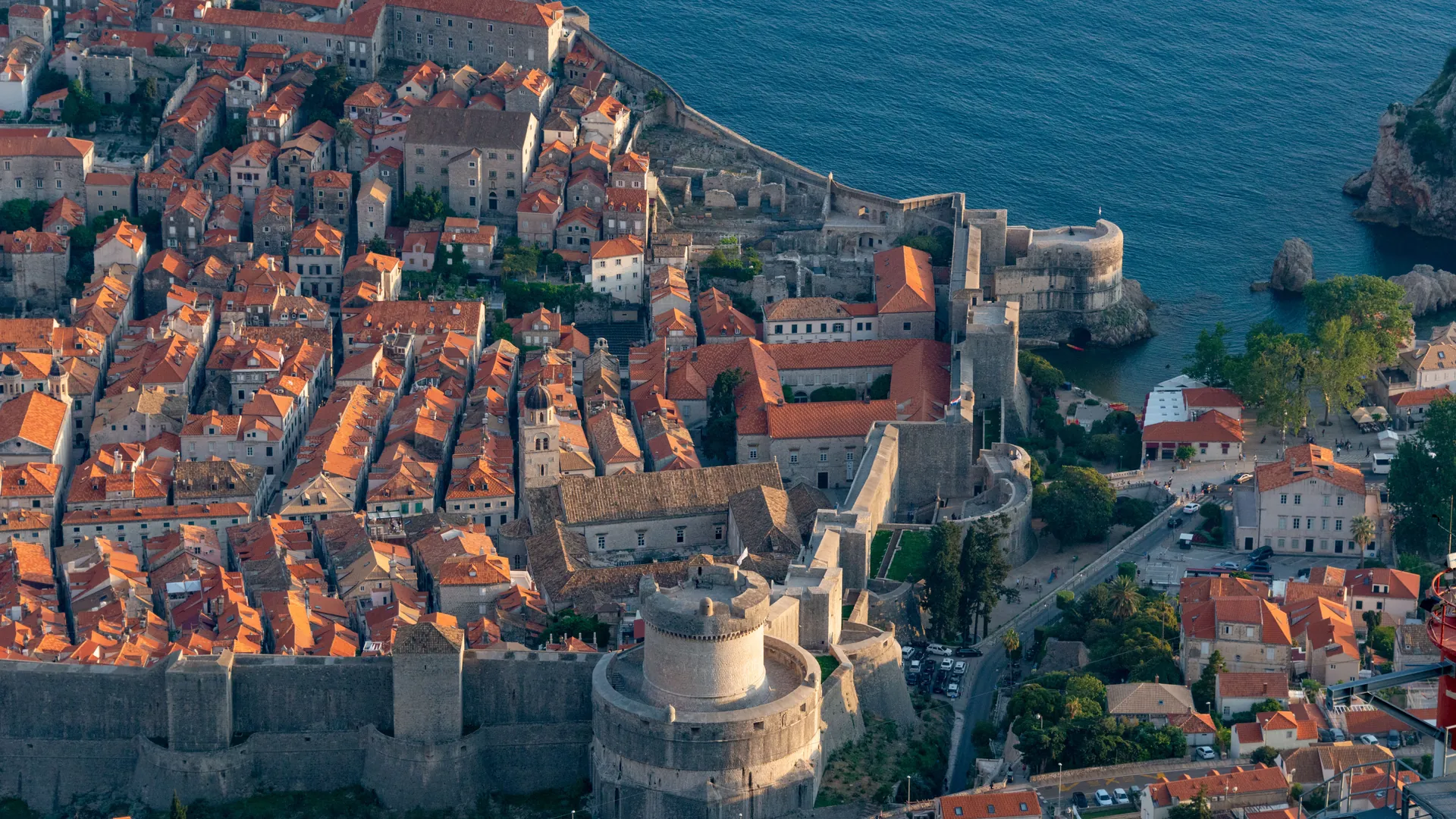 Dubrovnik's walled Old Town from above, its red rooftops ringed by stone fortifications against the Adriatic