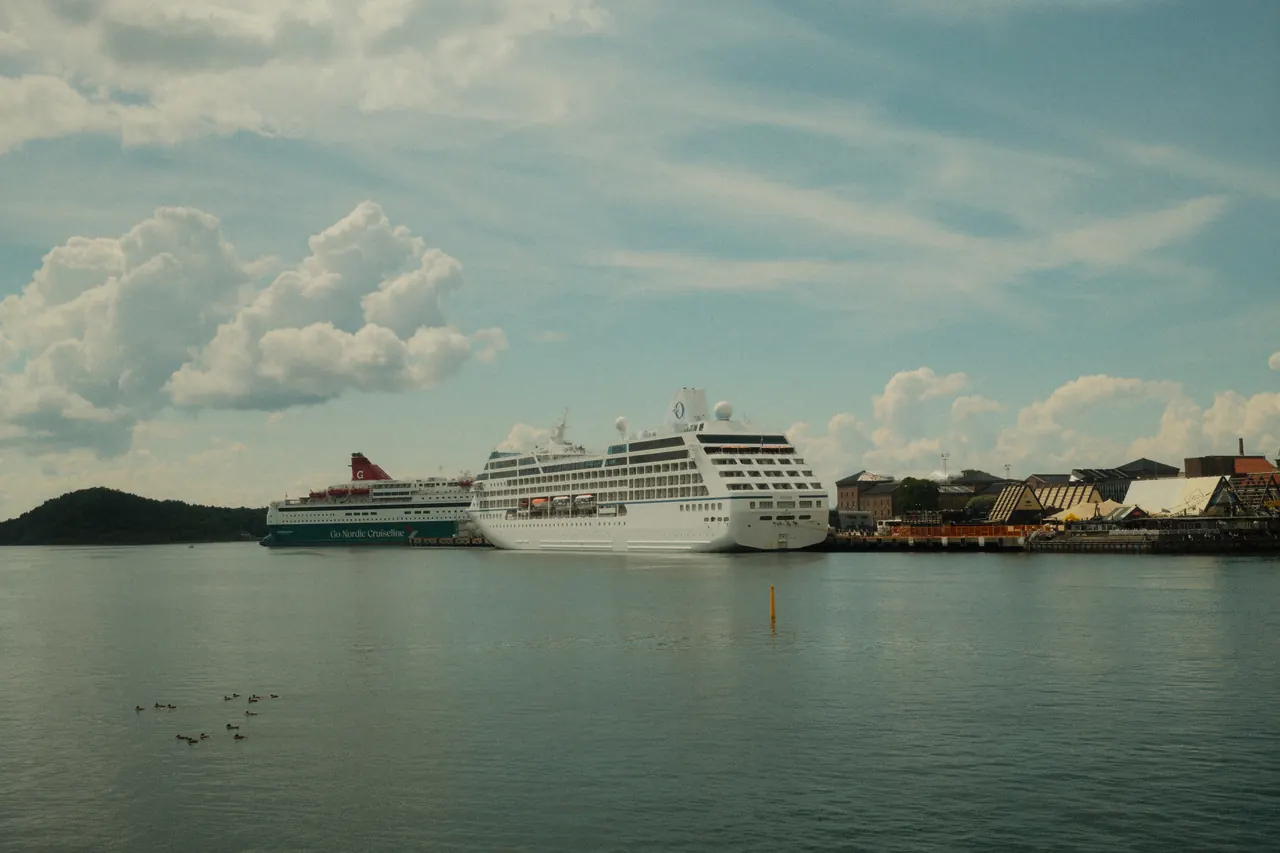 Cruise ships docked at a calm port under a cloudy sky, showcasing travel and leisure. Perfect for marine themes.