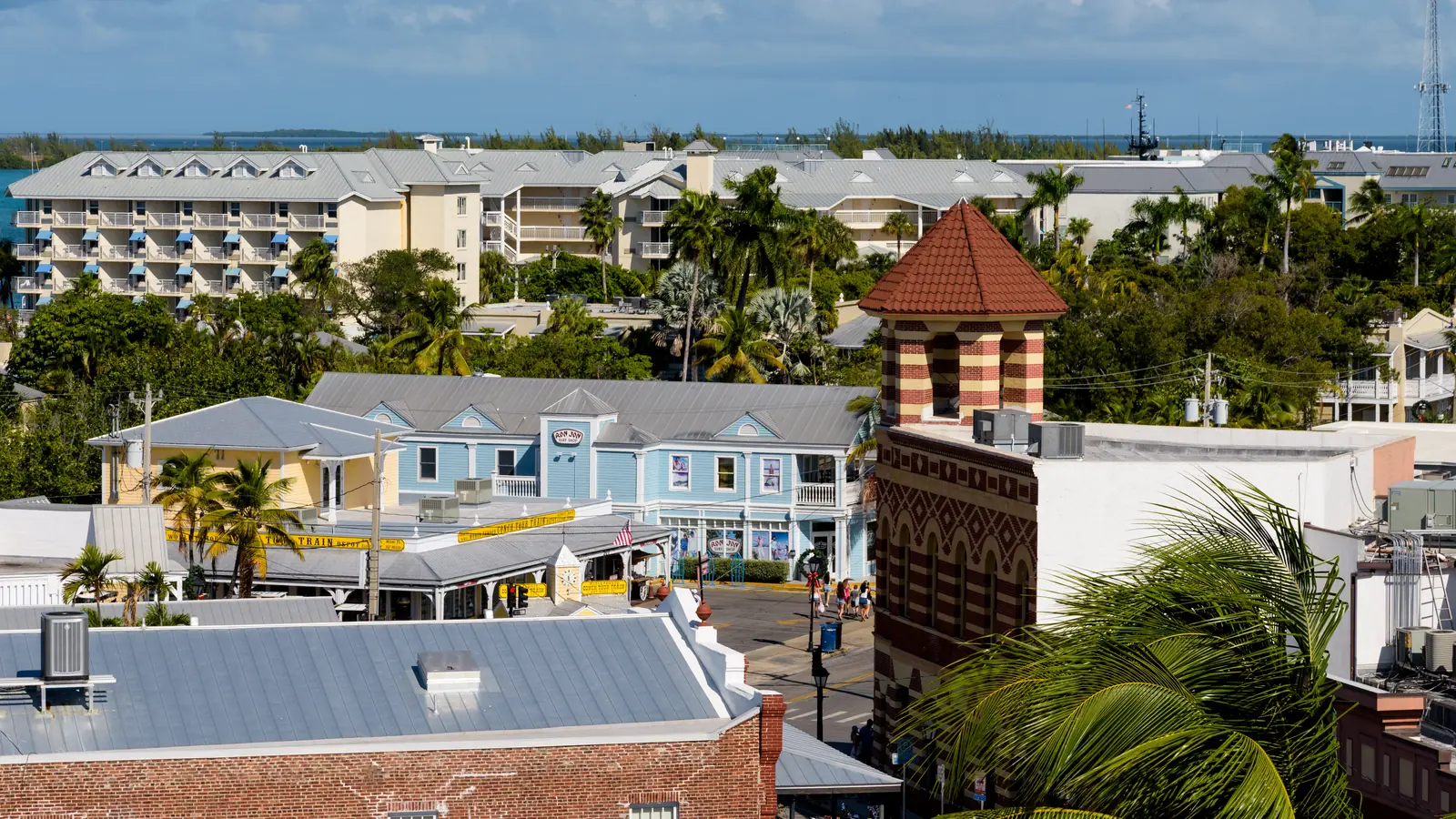 Historic buildings on the corner of Front and Duval Street in Key West under a bright sky