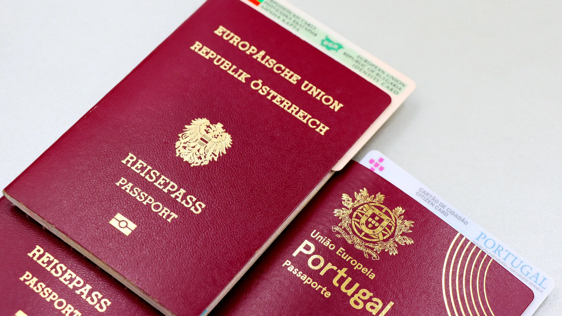 Two passports and a national identity card laid out on a desk