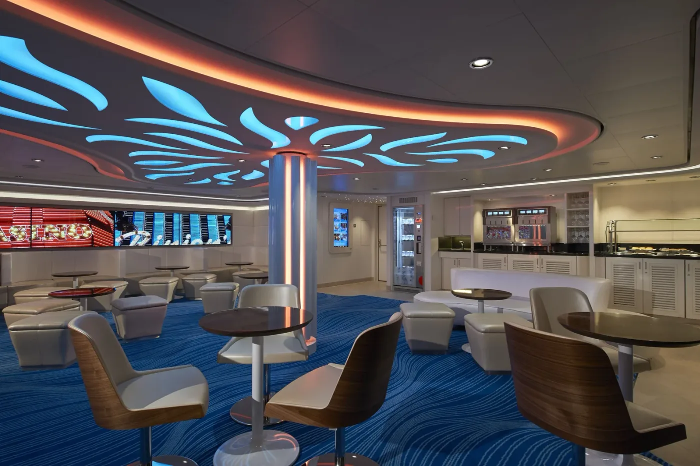 The keycard-access Studio Lounge on a Norwegian ship, with seating and a coffee station