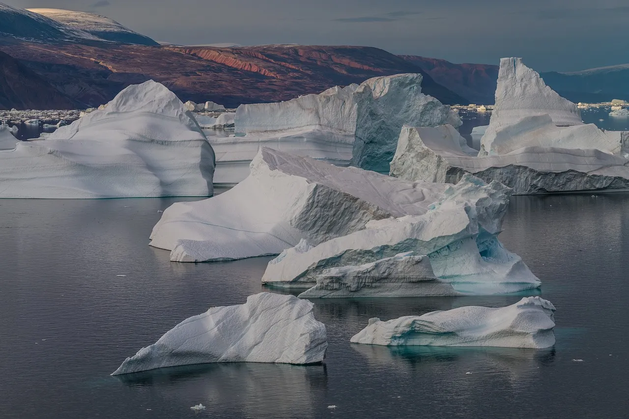 An expedition vessel in pack ice beside a massive iceberg in polar waters