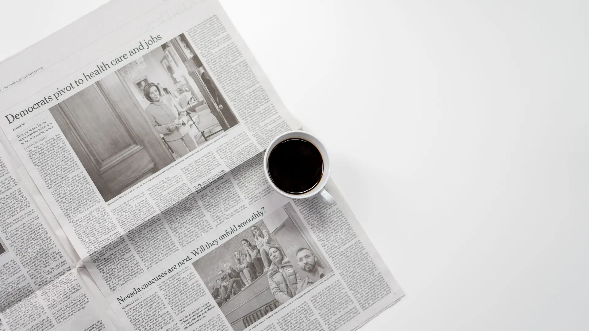 A cup of coffee resting on a folded newspaper
