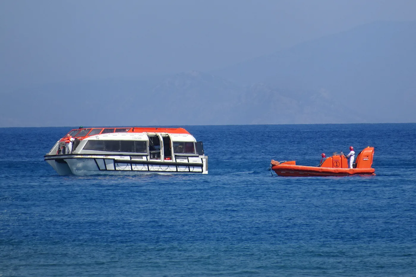A Rhapsody of the Seas lifeboat tender alongside in the port of Rhodes