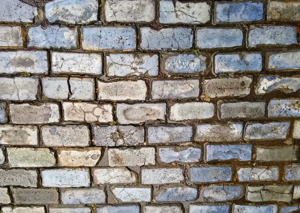Blue-grey adoquines cobblestones paving a street in Old San Juan, worn smooth and set in tight rows