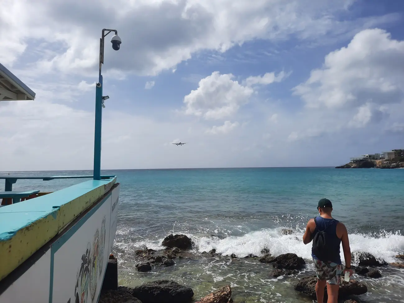 A passenger jet on final approach passing low over sunbathers at Maho Beach