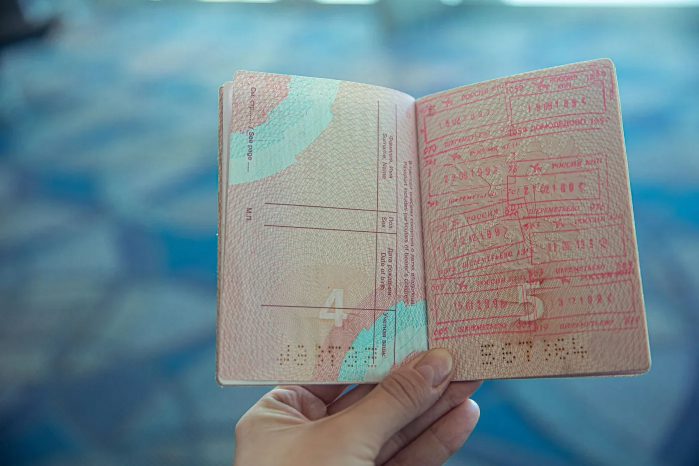 An open passport showing immigration entry stamps