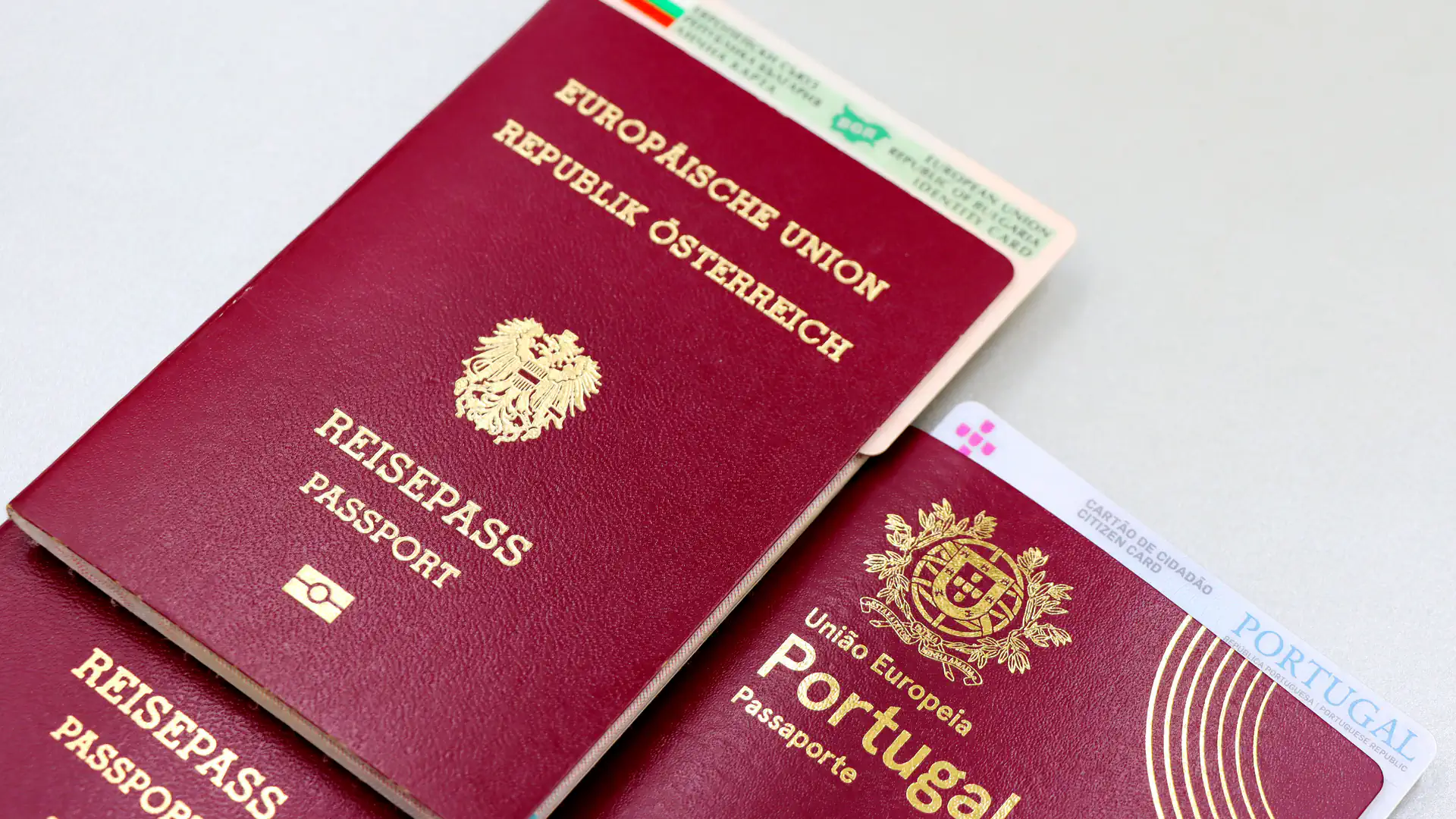 Several passports and identity cards laid out on a surface