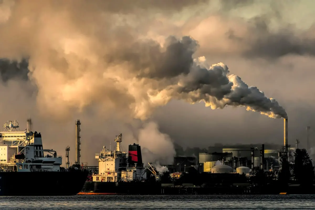 A fuel depot at dusk — bunker fuel volatility feeds straight into ticket prices