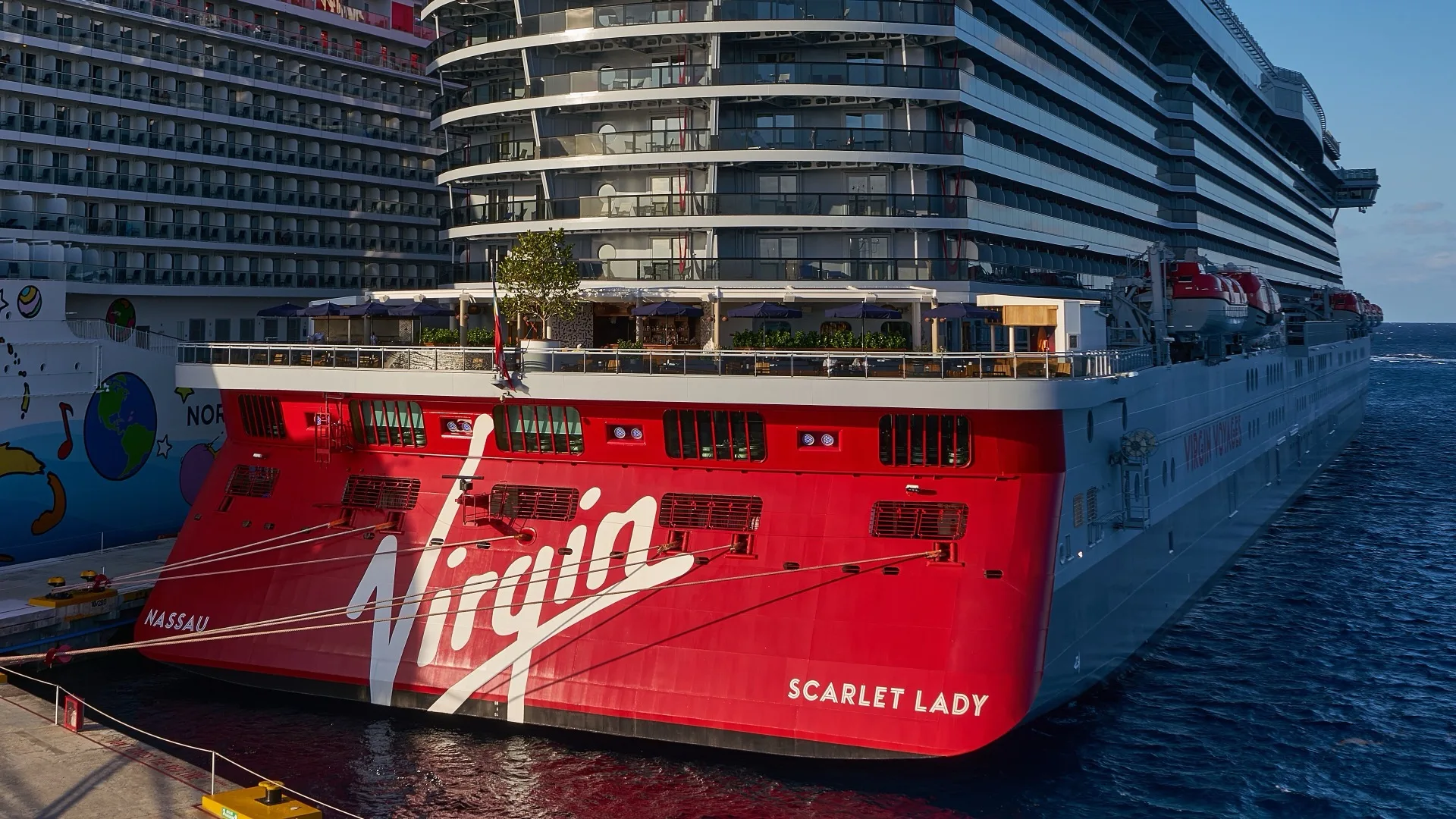 Virgin Voyages' Scarlet Lady berthed at Cozumel alongside a larger mainstream cruise ship