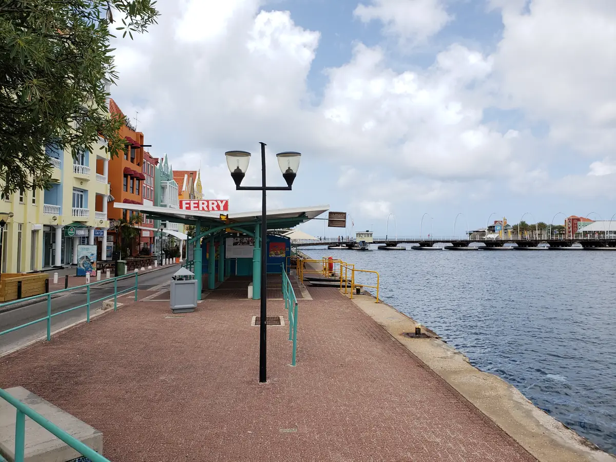 The Queen Emma pontoon bridge stretched across the channel beside its ferry station in Willemstad