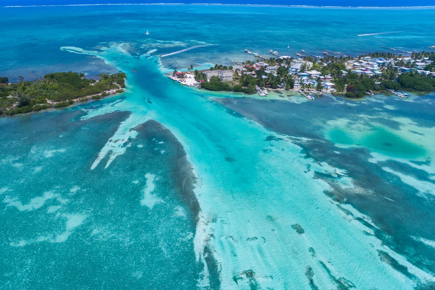 Aerial view of Caye Caulker and the Belize Barrier Reef — the day trips worth leaving the tender pier for