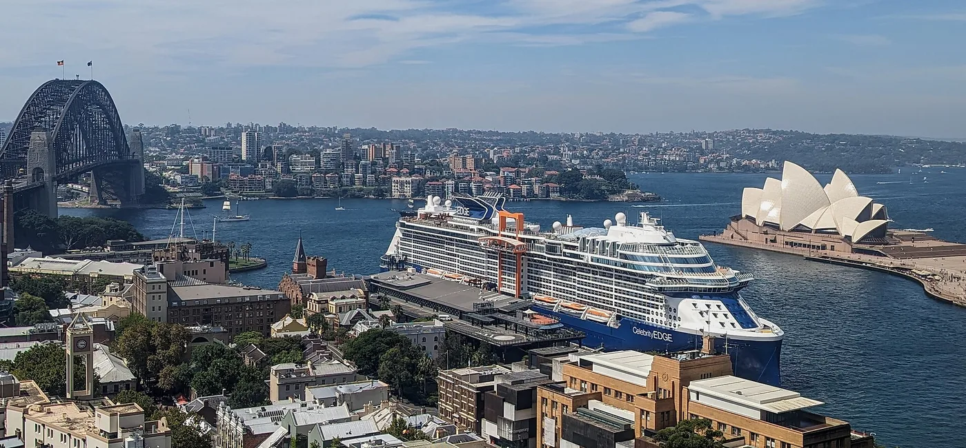 Celebrity Edge berthed in Sydney Harbour, with the Opera House and Harbour Bridge behind