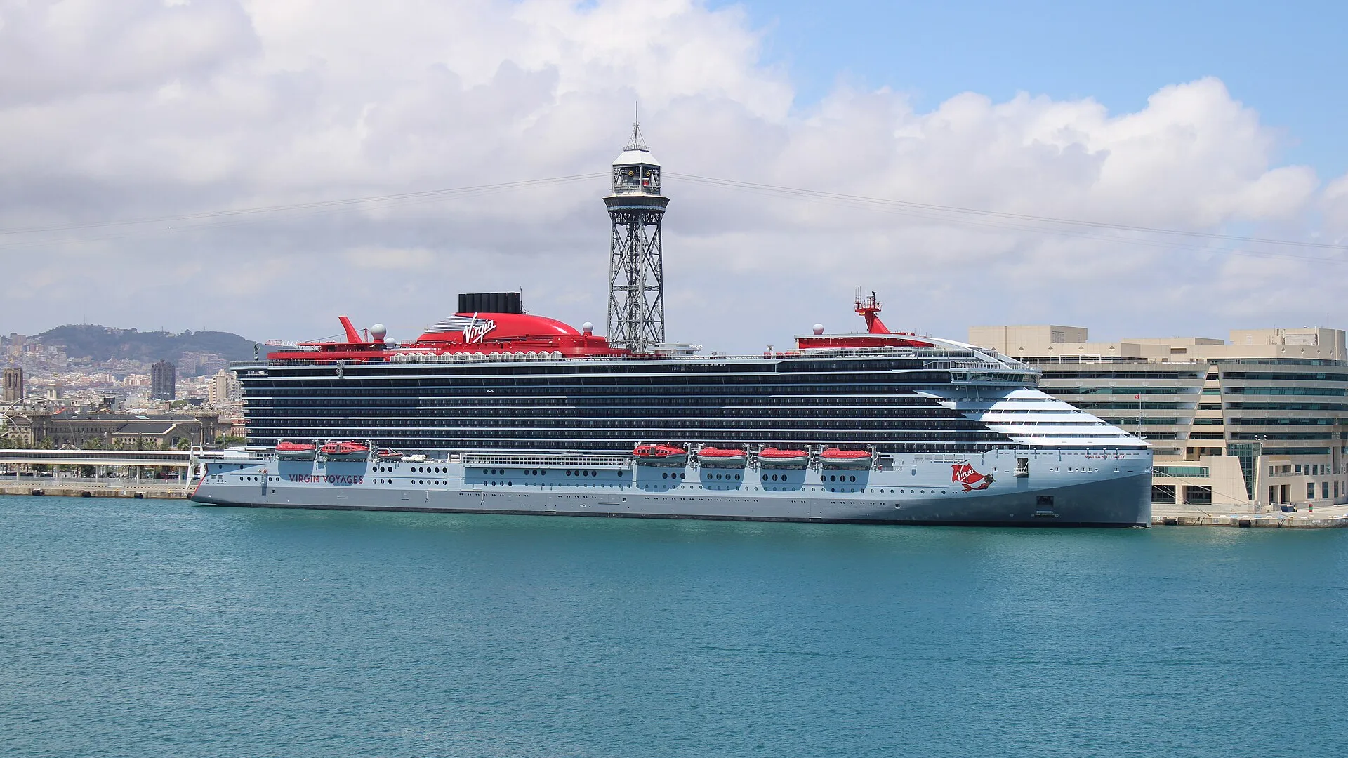 Virgin Voyages' Valiant Lady berthed at Barcelona under a bright sky